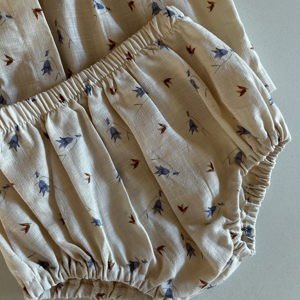 delicate bluebell and brown leaf design on latte cream cotton linen fabric