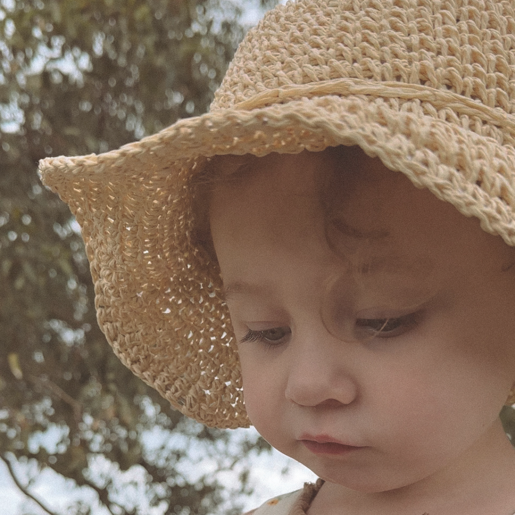 Neutral kids straw hat available in light and dark tones, perfect for year-round wear